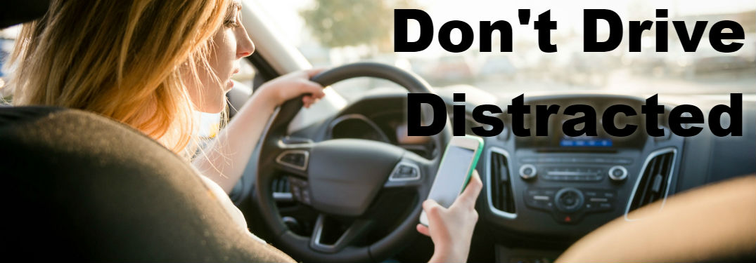 image of women texting and driving - Don't Drive Distracted - Distracted Driving Awareness Month