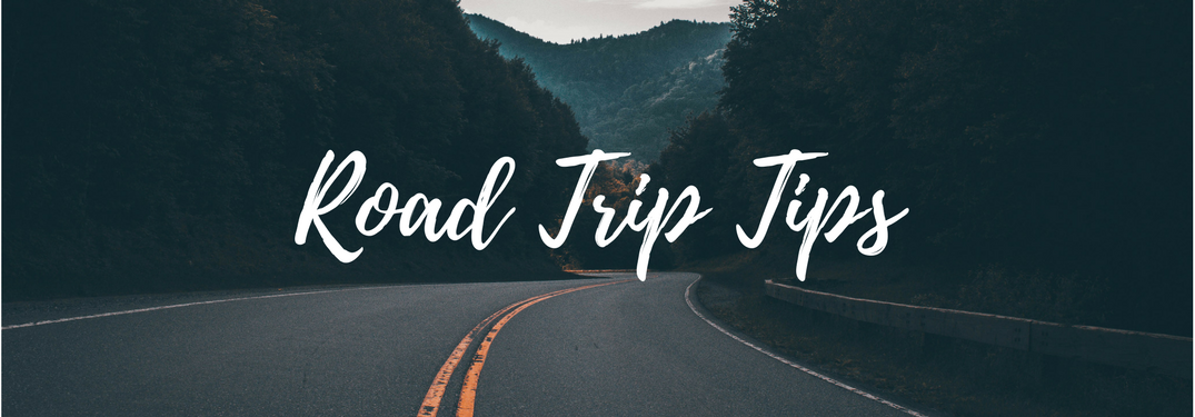 empty road in mountains at night with text "road trip tips"
