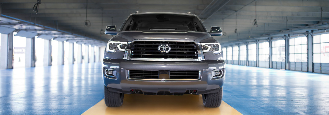front grille and bumper of gray 2018 toyota sequoia in large, empty warehouse