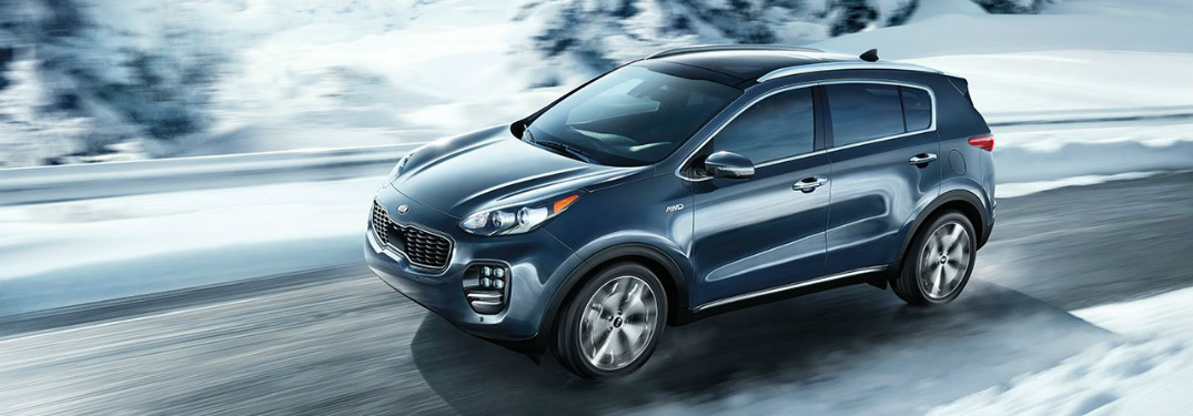 Blue 2018 Kia Sportage driving on snowy road