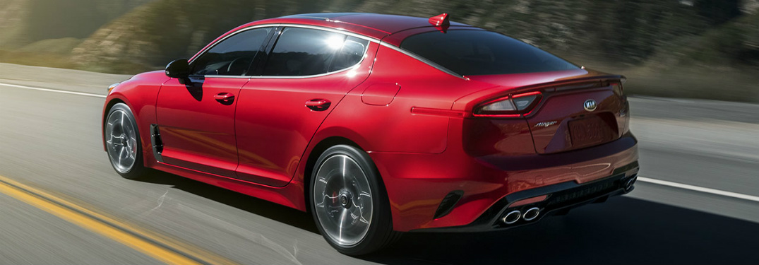 Red 2018 Kia Stinger driving on open road