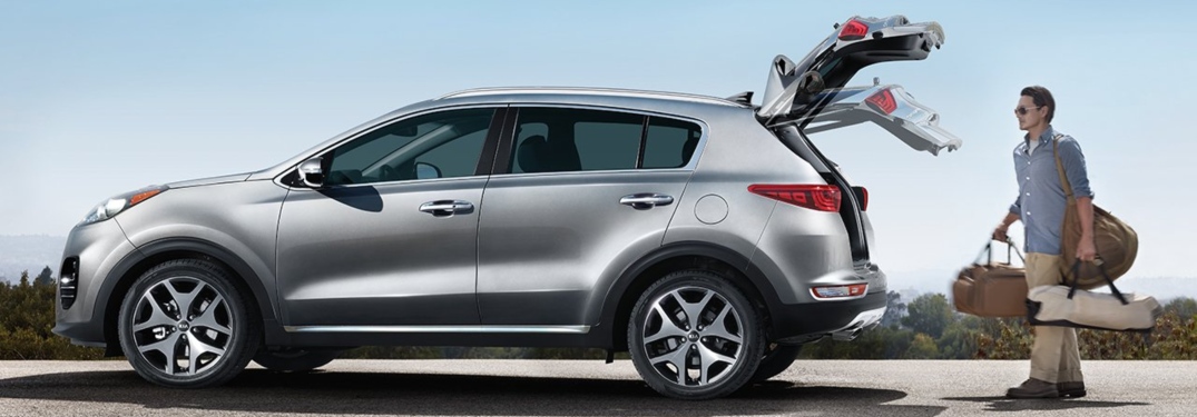 Man loading luggage into the 2019 Kia Sportage