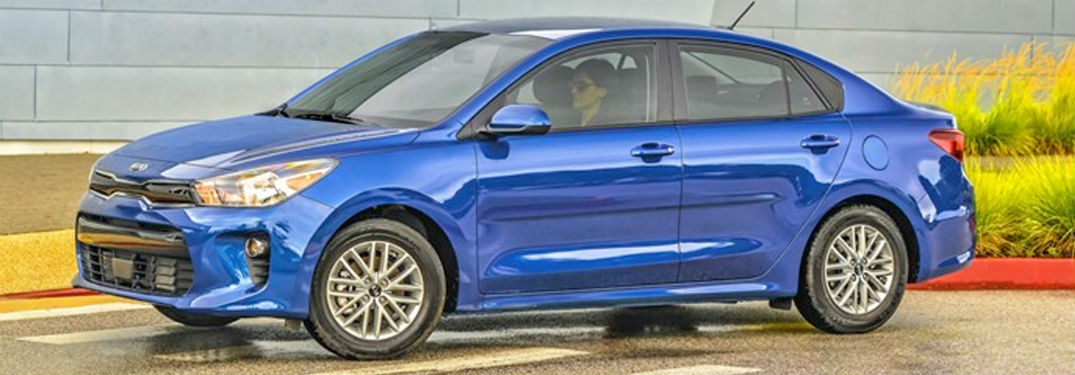 2020 Kia Rio blue exterior front fascia driver side parked woman inside