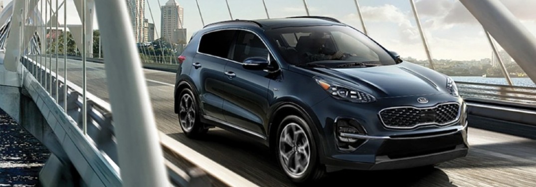 2021 Kia Sportage blue exterior front fascia passenger side driving on bridge