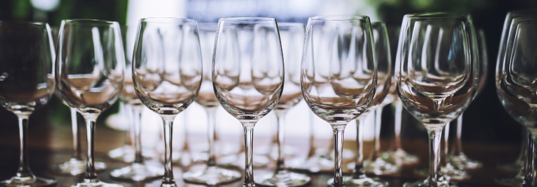 several wine glasses on top of a wooden table