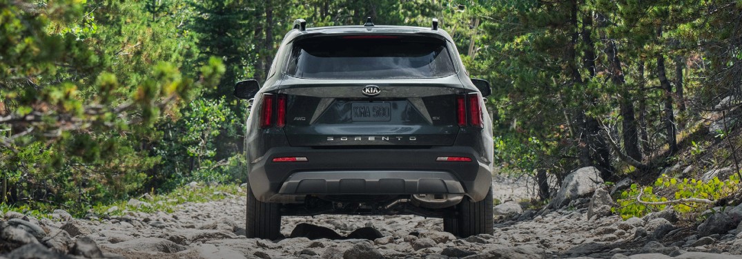 2021 Kia Sorento black exterior rear fascia driving on rocky path in forest
