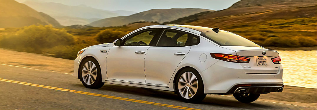 2018 kia optima from rear on rural road