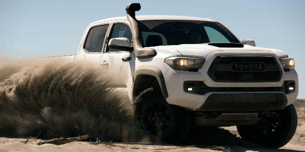 Super White 2019 Toyota Tacoma TRD Pro Kicking Up Sand in Desert