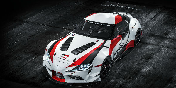 Overhead View of Red, White and Black Toyota GR Supra Concept on Black Asphalt