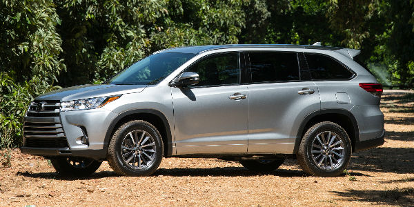 Silver 2018 Toyota Highlander on Dirt Road in Forest