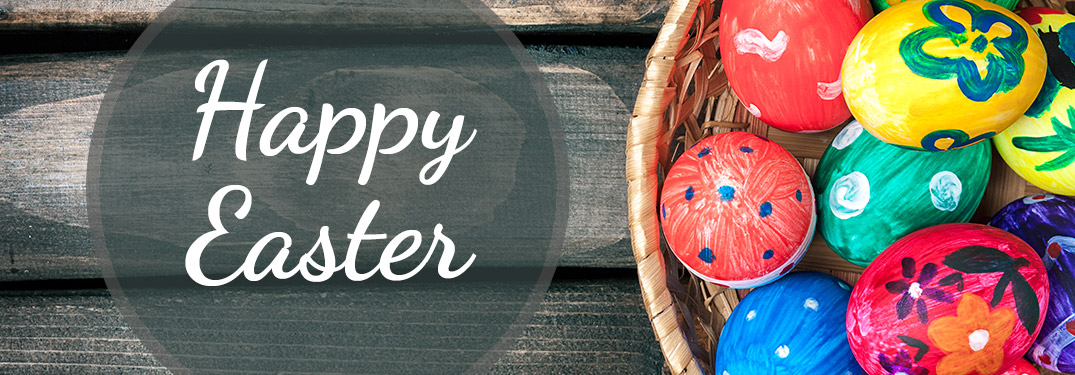 Colorful Easter Eggs in a Basket on a Wood Table with White Happy Easter Text