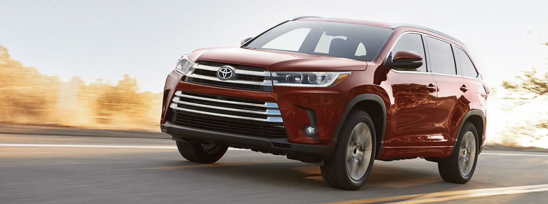 Ooh La La Rouge Mica 2018 Toyota Highlander Driving on a Country Highway