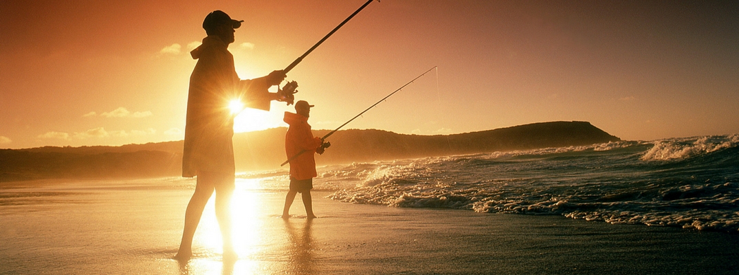 Two Men Fishing on the Beach at Sunrise