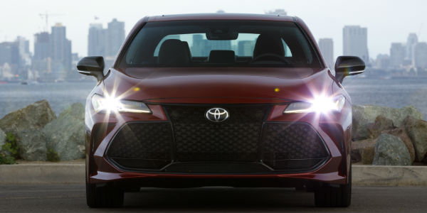 2019 Toyota Avalon Touring Grille and Headlights with City Skyline in the Background