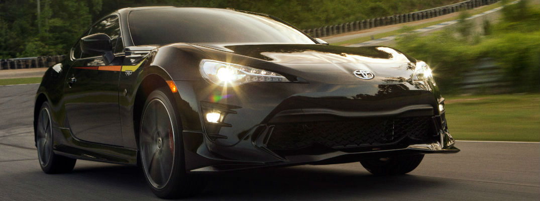 Black 2019 Toyota 86 with TRD Tri-Color Graphic on a Country Road at Dusk