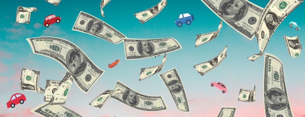 Money and cars rain down on a sunset sky