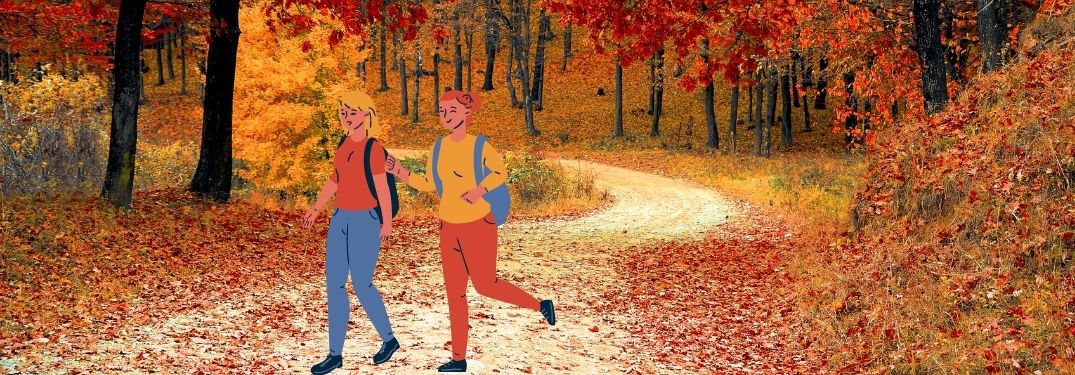 Cartoon women joyfully hike through autumn woods