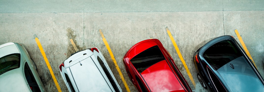 unidentifiable cars from various brands viewed from above in a used car lot and cropped in an artsy manner