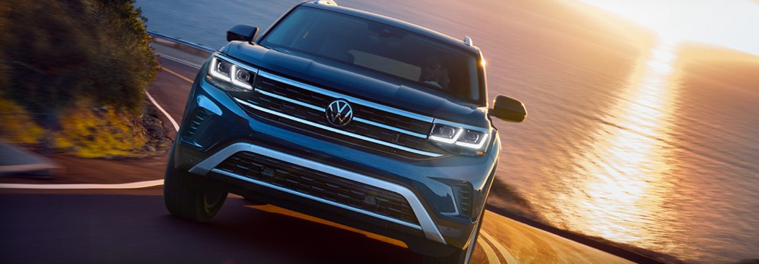 2021 Volkswagen Atlas driving down a curving road at sunset