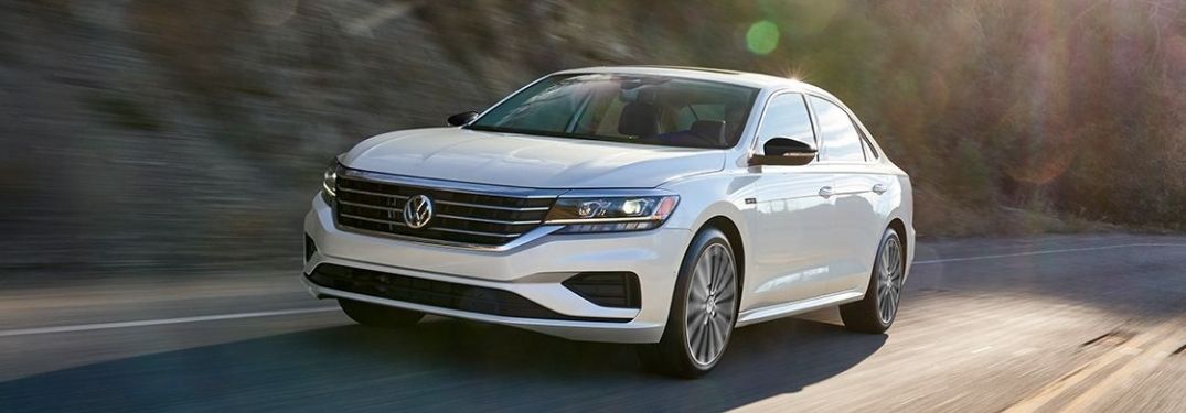 A white 2022 VW Passat driving on the highway.