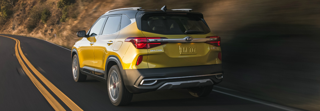 Passenger's side rear angle view of yellow 2021 Kia Seltos