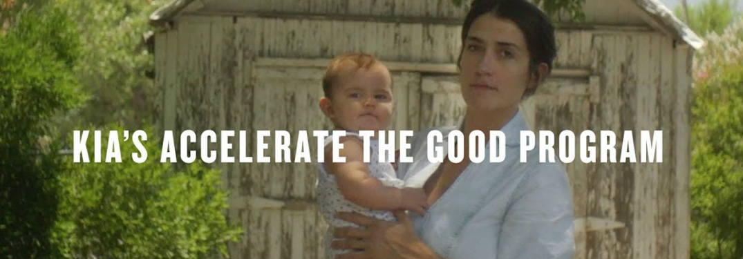 Kia's Accelerate the Good Program title and a woman holding a baby