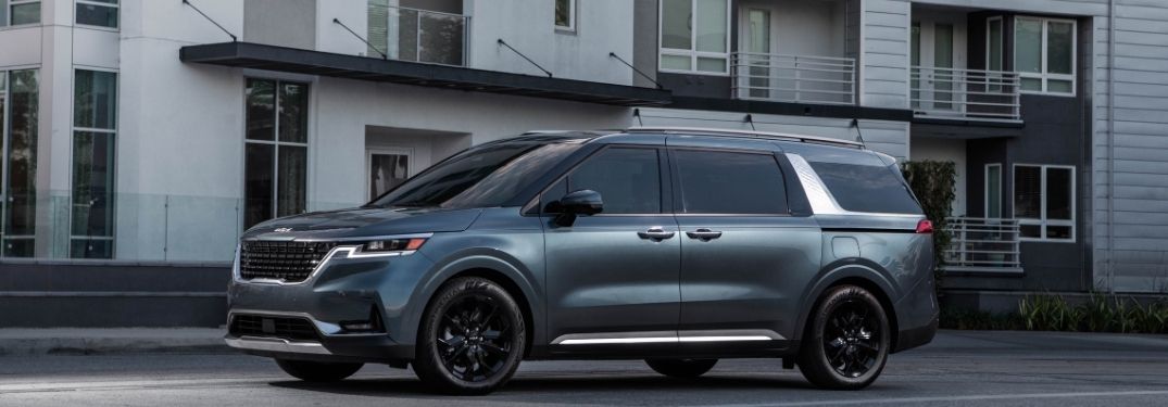 2022 Kia Carnival exterior driver side profile in front of building