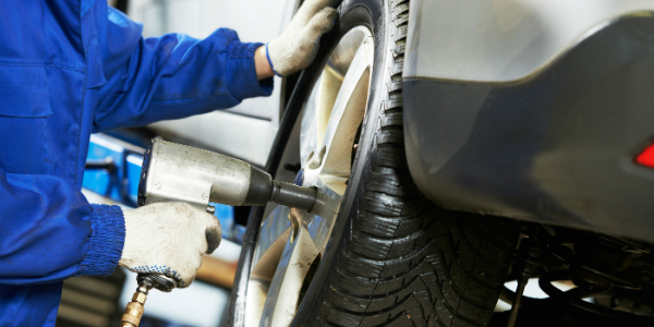 Technician Using an Impact Wrench on Lug Nuts