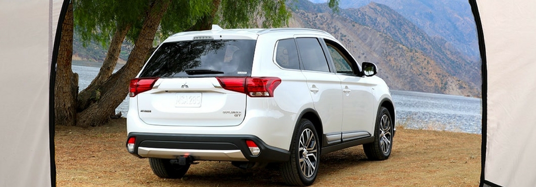 Rear profile of the 2018 Mitsubishi Outlander framed by a tent