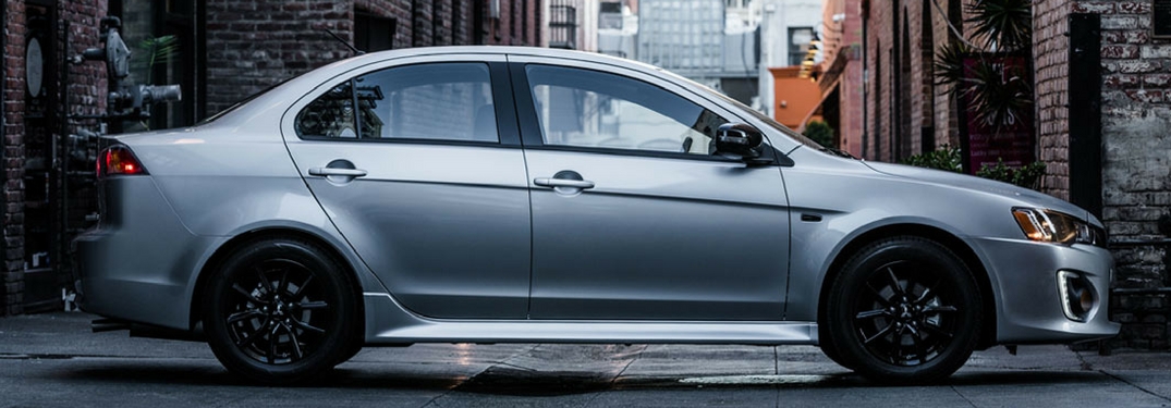 Side profile of the 2017 Mitsubishi Lancer parked between two buildings