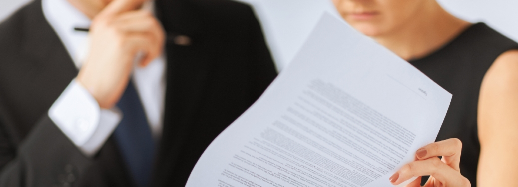 A man and woman ponder over a tax document.