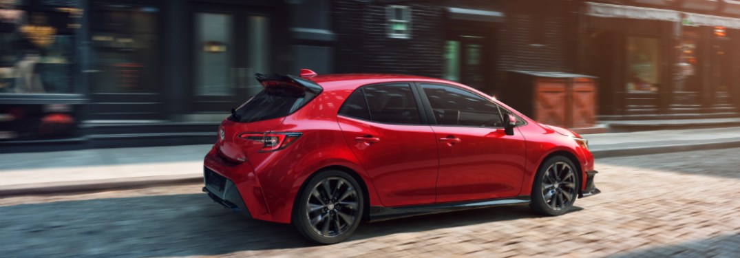2021 Toyota Corolla Hatchback driving down a city street