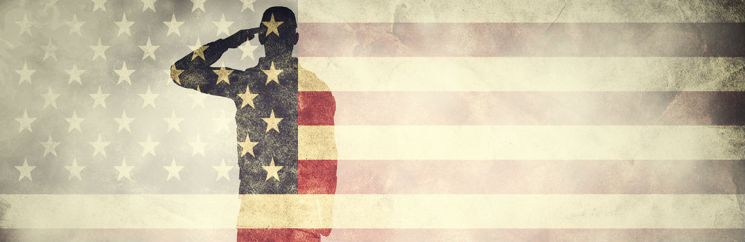 silhouette of American soldier behind American flag