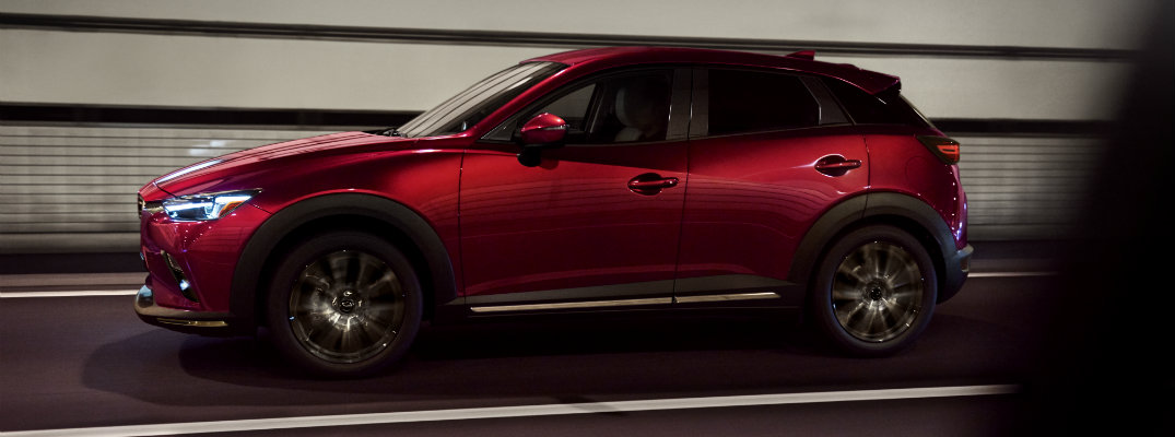 2019 Mazda CX-3 exterior side shot red paint job driving through a lit tunnel