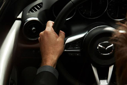 2019 Mazda man gripping steering wheel