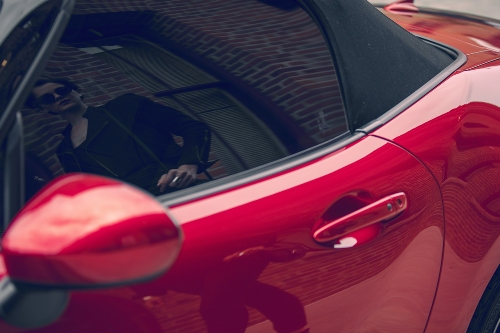 2019 MX-5 Miata with passerby reflected in the window and paint