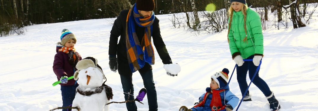 family building a snowman