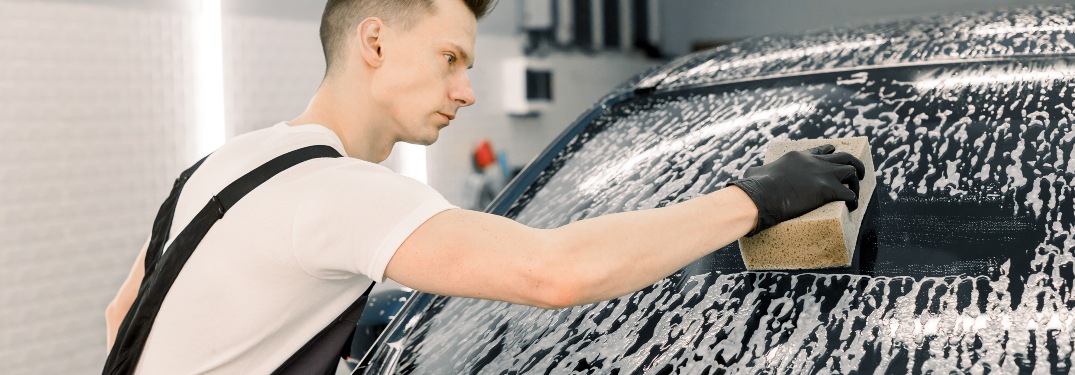 person washing windshield