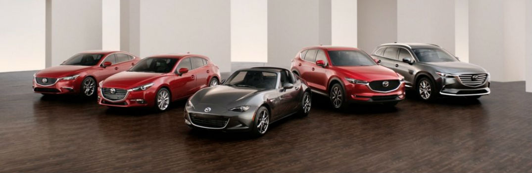 five Mazda models lined up in a showroom