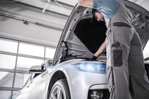 mechanic working on head light
