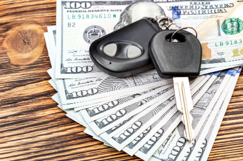 keys sitting on top of cash