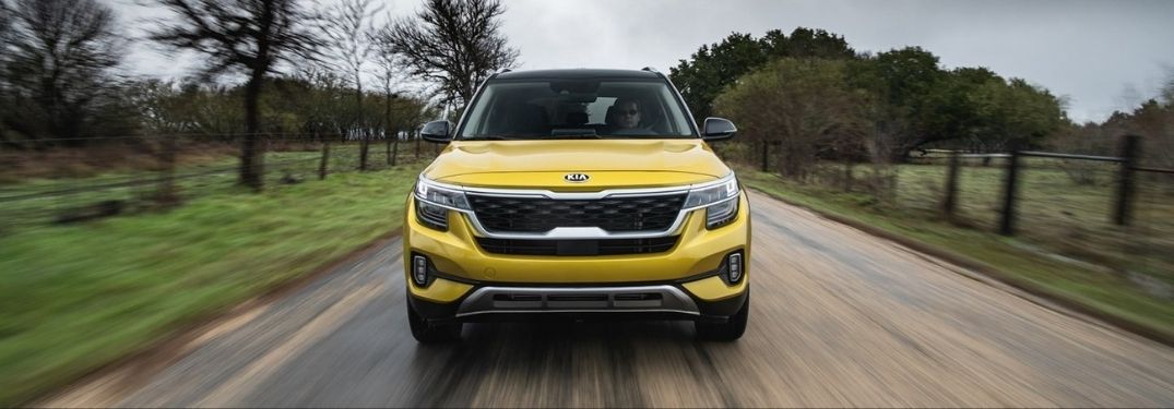 Exterior view of the front of a yellow 2021 Kia Seltos
