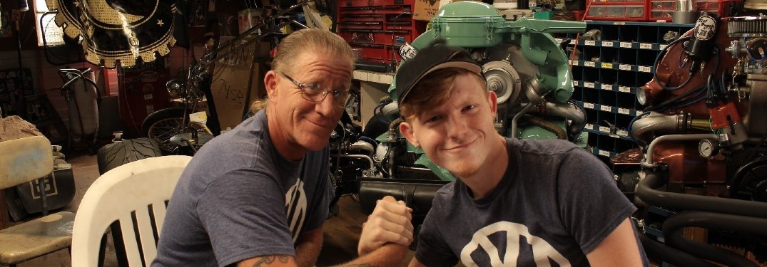 a image father and son duo holding hands in garage