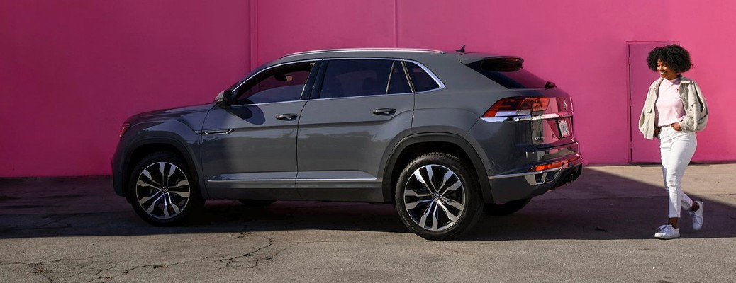 woman walking past a 2020 VW Atlas pink wall