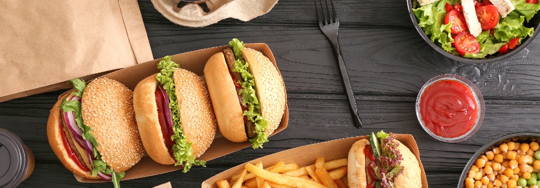 wooden table with different food from delivery order