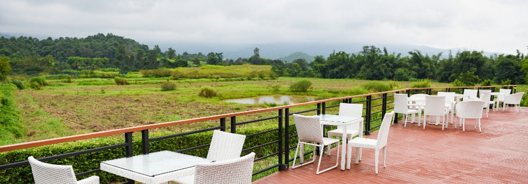white tables and chairs on patio in countryside