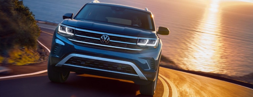 2021 Volkswagen Atlas driving down road near body of water.