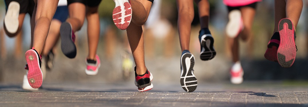 Group of people running with only legs and feet in view