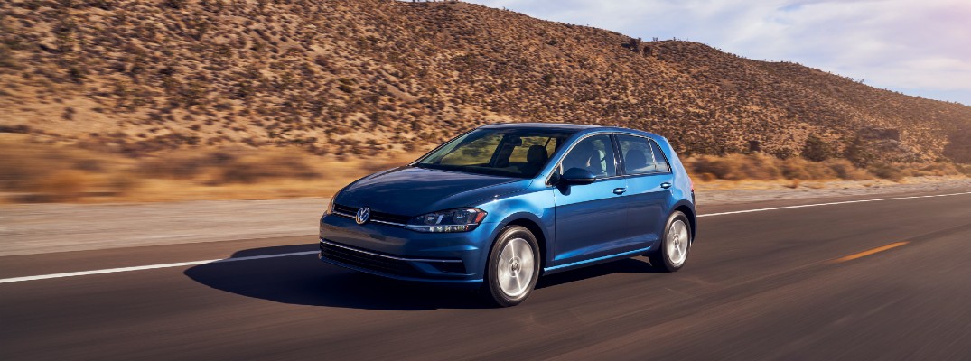 A front left quarter photo of the 2021 Volkswagen Golf on the road.