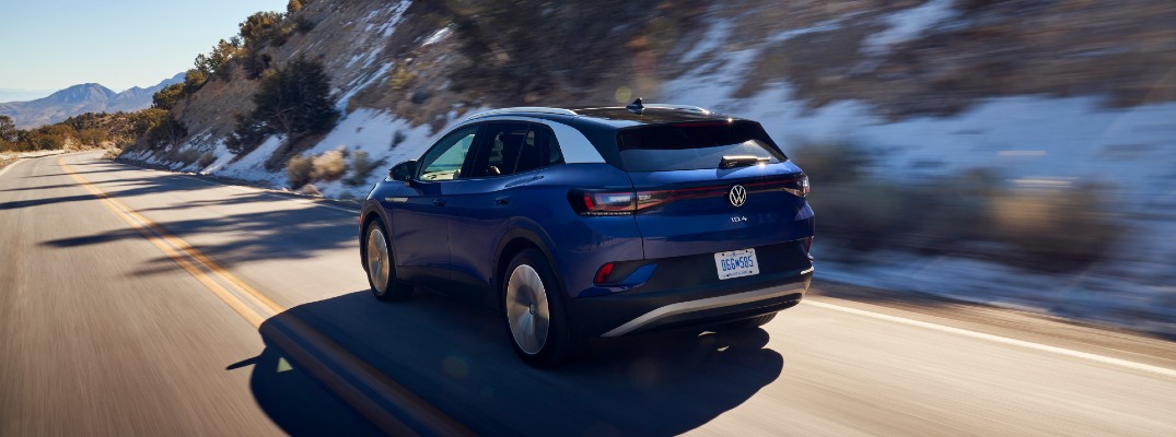 A rear left quarter photo of the 2021 Volkswagen ID.4 on the road.